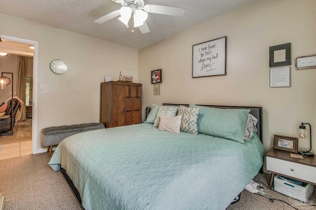 bedroom featuring carpet, a textured ceiling, and ceiling fan