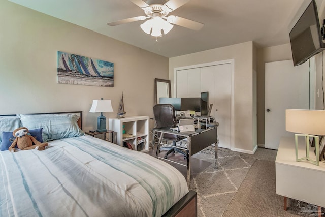 carpeted bedroom featuring ceiling fan and a closet