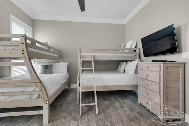 bedroom with ornamental molding, ceiling fan, and dark wood-type flooring