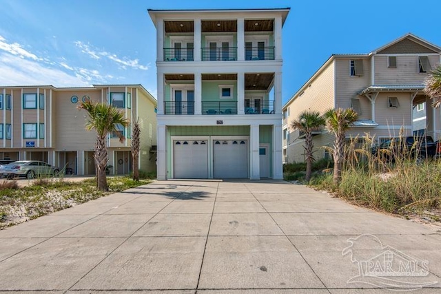 coastal home featuring a balcony and a garage