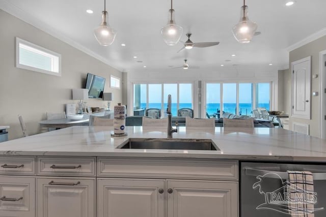 kitchen with pendant lighting, dishwashing machine, a wealth of natural light, and ornamental molding