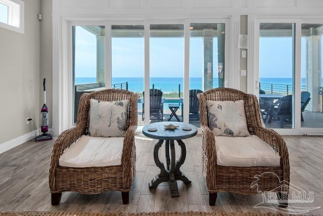 living area with a water view and hardwood / wood-style flooring