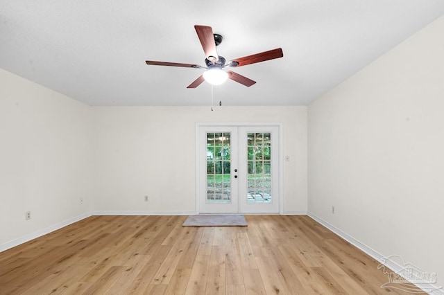 spare room featuring ceiling fan, french doors, and light hardwood / wood-style floors