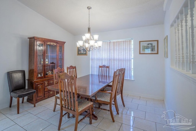 tiled dining area with lofted ceiling and a chandelier