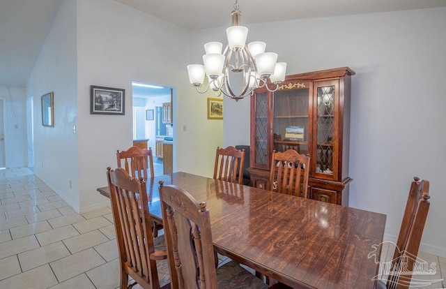 dining space with lofted ceiling and a chandelier