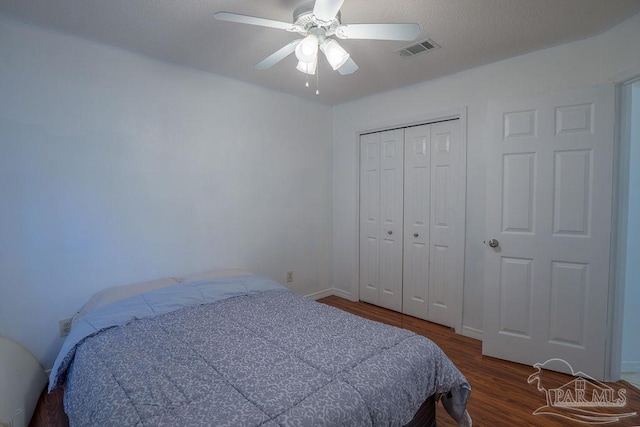 bedroom featuring a closet, ceiling fan, and dark hardwood / wood-style flooring