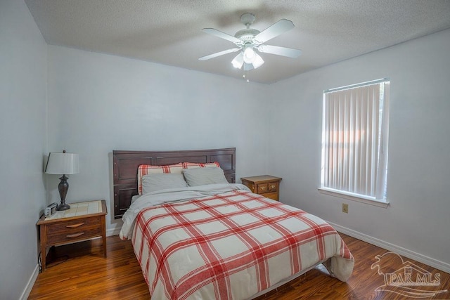 bedroom featuring ceiling fan, a textured ceiling, and hardwood / wood-style floors