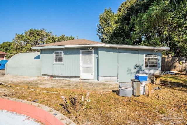 rear view of property with an outdoor structure