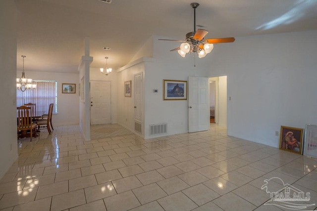 interior space with high vaulted ceiling, ceiling fan with notable chandelier, and light tile patterned floors