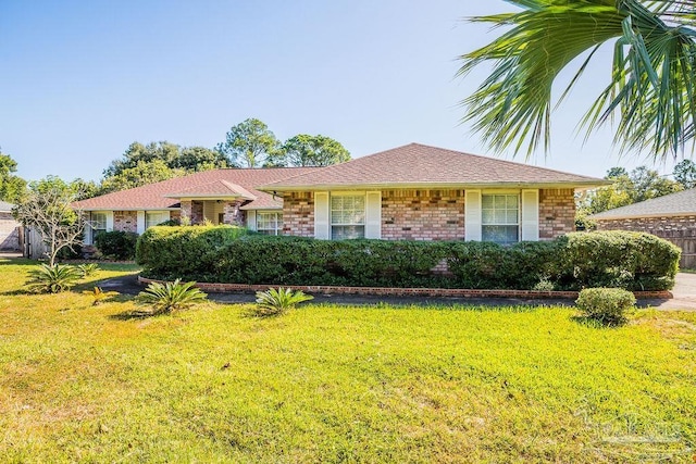 single story home featuring a front lawn