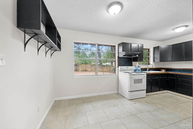 kitchen with electric stove, a textured ceiling, and light tile patterned flooring