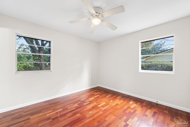 spare room with hardwood / wood-style flooring and ceiling fan