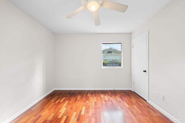 spare room with hardwood / wood-style floors and ceiling fan