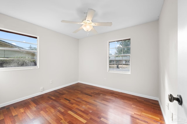 spare room featuring dark hardwood / wood-style floors and ceiling fan