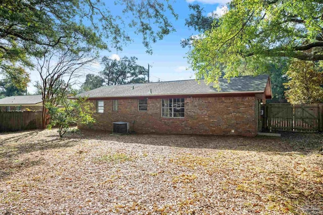 back of house with central AC unit