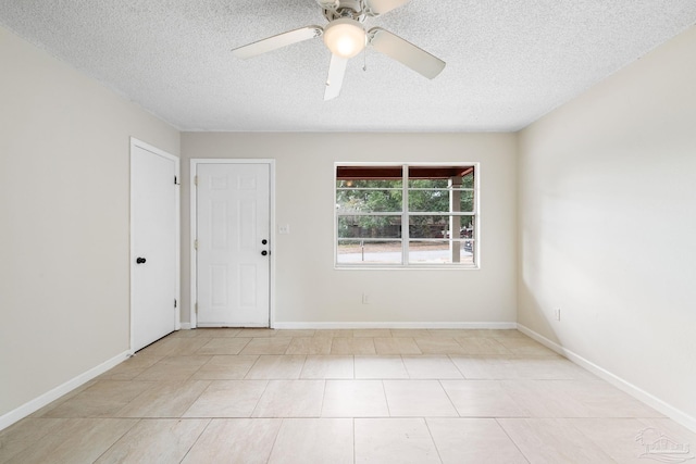 spare room featuring ceiling fan and a textured ceiling