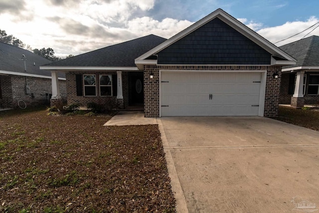 4483 Watkins St, Pace, FL 32571 - ranch-style home with brick siding, an attached garage, and concrete driveway