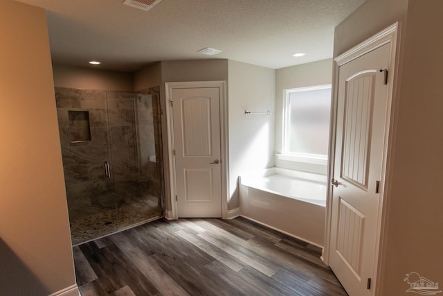 4483 Watkins St, Pace, FL 32571 - bathroom with a stall shower, a garden tub, wood finished floors, recessed lighting, and baseboards