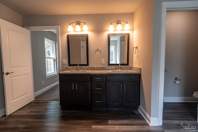 4483 Watkins St, Pace, FL 32571 - full bathroom featuring wood finished floors, baseboards, double vanity, and toilet