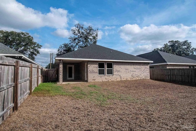 4483 Watkins St, Pace, FL 32571 - back of property with brick siding and a patio area