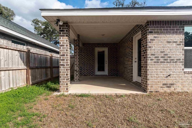 4483 Watkins St, Pace, FL 32571 - property entrance featuring brick siding, fence, and a patio