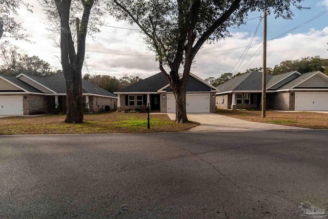 4483 Watkins St, Pace, FL 32571 - ranch-style house with concrete driveway, a garage, brick siding, and a front lawn