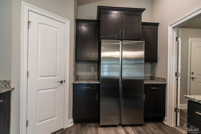 4483 Watkins St, Pace, FL 32571 - kitchen featuring freestanding refrigerator, wood finished floors, light stone counters, and dark brown cabinetry