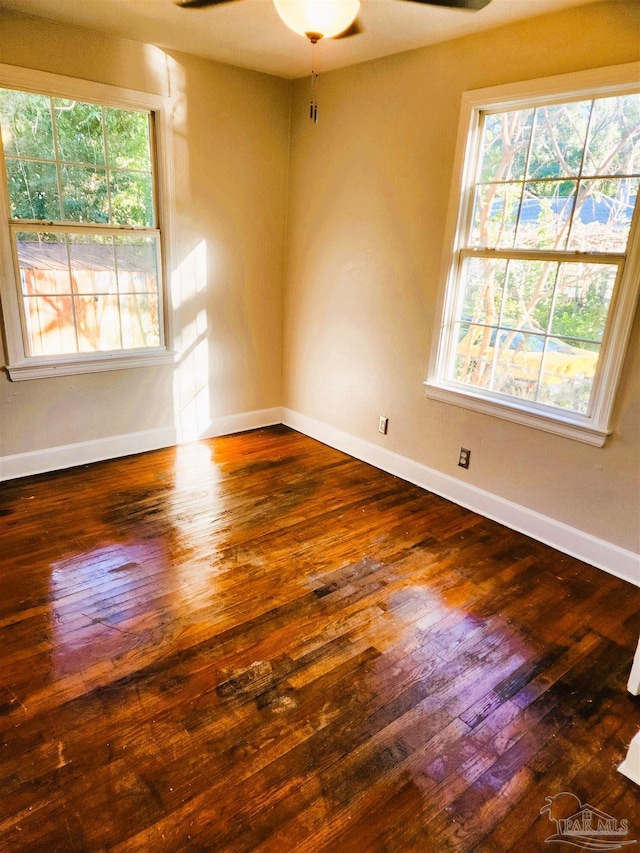 spare room featuring dark hardwood / wood-style flooring and ceiling fan