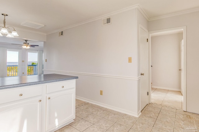 kitchen featuring ornamental molding, ceiling fan with notable chandelier, pendant lighting, light tile patterned floors, and white cabinetry