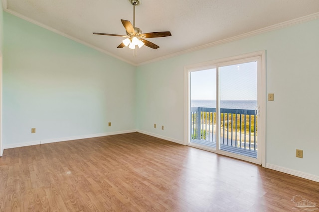 unfurnished room with ceiling fan, a water view, light wood-type flooring, and crown molding