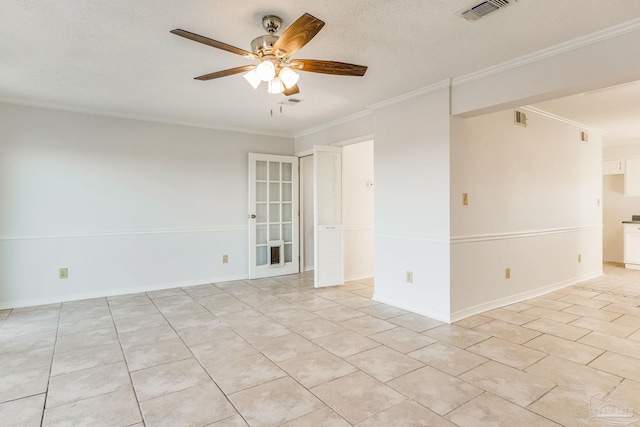 tiled spare room featuring ceiling fan, ornamental molding, and a textured ceiling