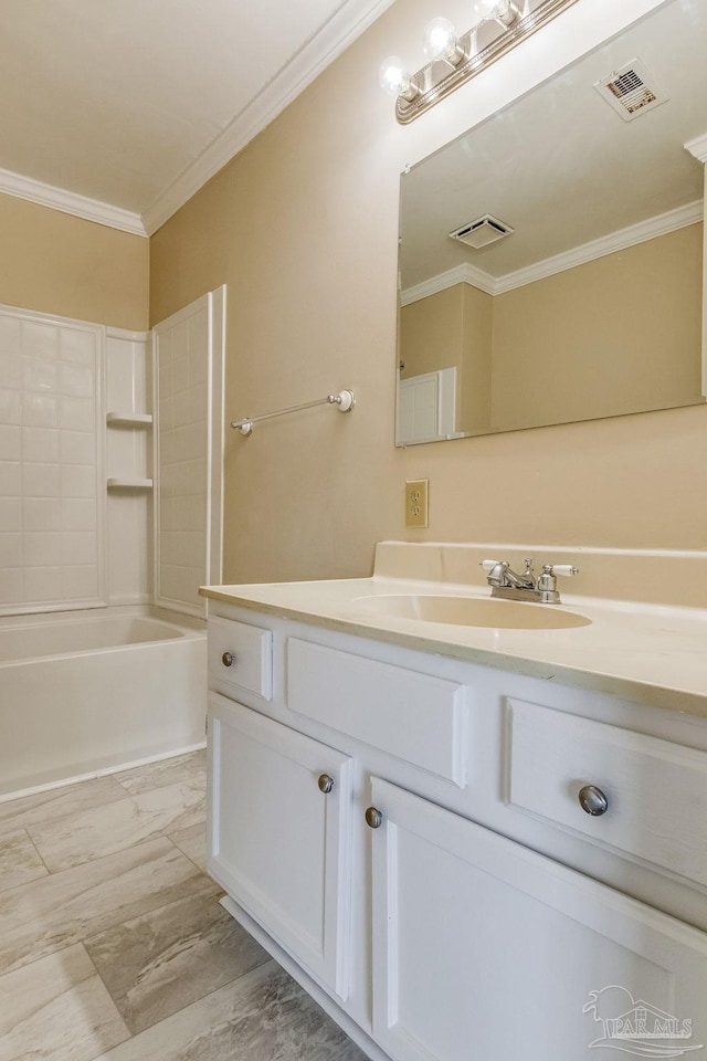 bathroom featuring bathing tub / shower combination, crown molding, and vanity