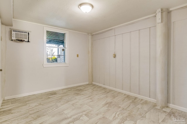 unfurnished room featuring a textured ceiling, a wall mounted AC, and crown molding