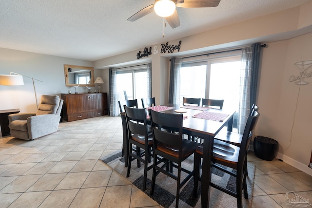 dining room featuring ceiling fan, a textured ceiling, and light tile patterned floors