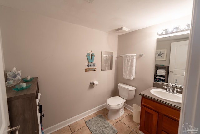 bathroom featuring toilet, visible vents, baseboards, tile patterned flooring, and vanity