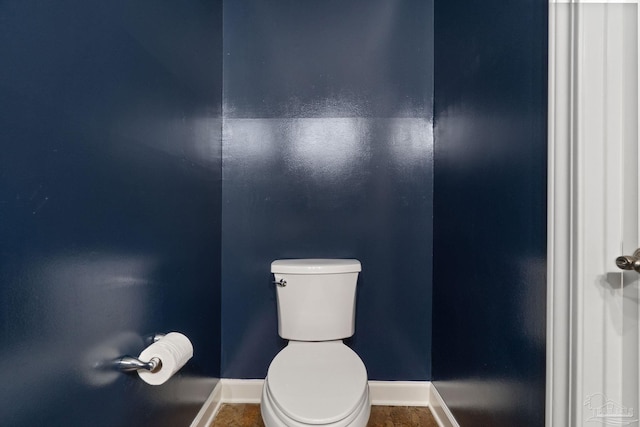 bathroom with baseboards and toilet