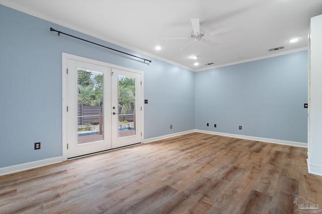 unfurnished room with crown molding, visible vents, baseboards, french doors, and a ceiling fan