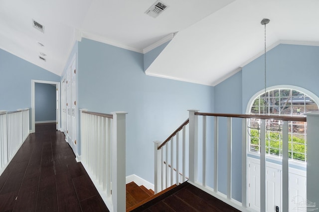 corridor featuring visible vents, an upstairs landing, wood-type flooring, and vaulted ceiling