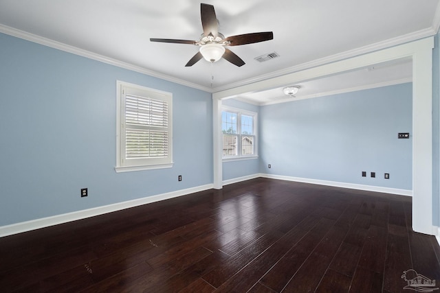 empty room featuring dark wood finished floors, ornamental molding, ceiling fan, baseboards, and visible vents