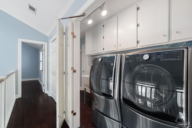clothes washing area featuring ornamental molding, washer and dryer, visible vents, and dark wood-style flooring