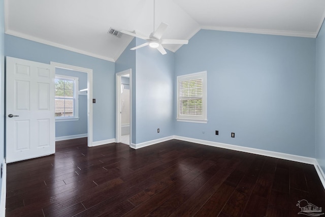 unfurnished bedroom featuring dark wood finished floors, visible vents, vaulted ceiling, and baseboards