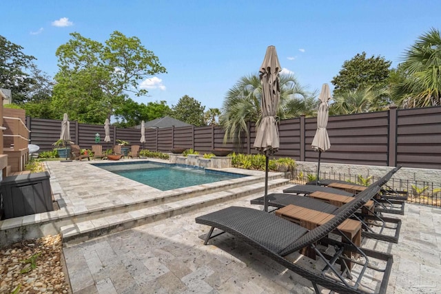 view of swimming pool with a fenced in pool, a fenced backyard, and a patio area
