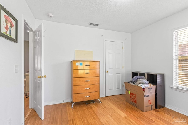 bedroom featuring a textured ceiling and hardwood / wood-style flooring