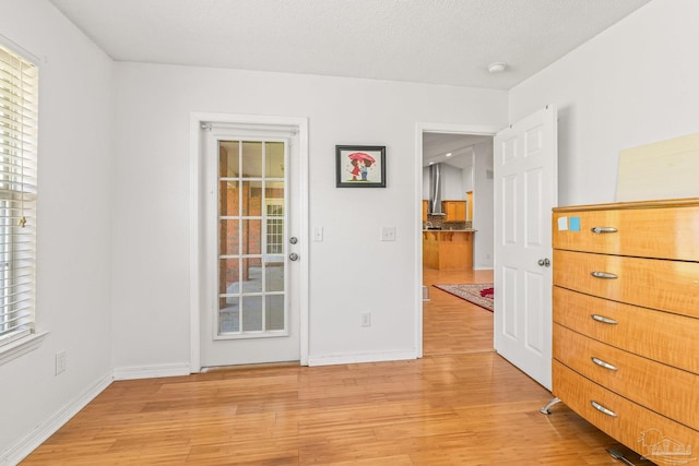 unfurnished bedroom featuring light hardwood / wood-style flooring and a textured ceiling