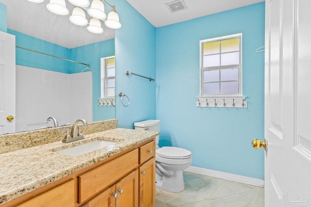 bathroom featuring tile patterned floors, vanity, and toilet