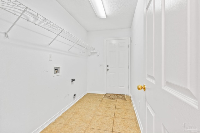 clothes washing area with electric dryer hookup, hookup for a washing machine, and light tile patterned floors