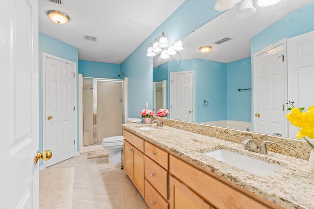 bathroom with a shower with door, tile patterned flooring, toilet, and double sink vanity