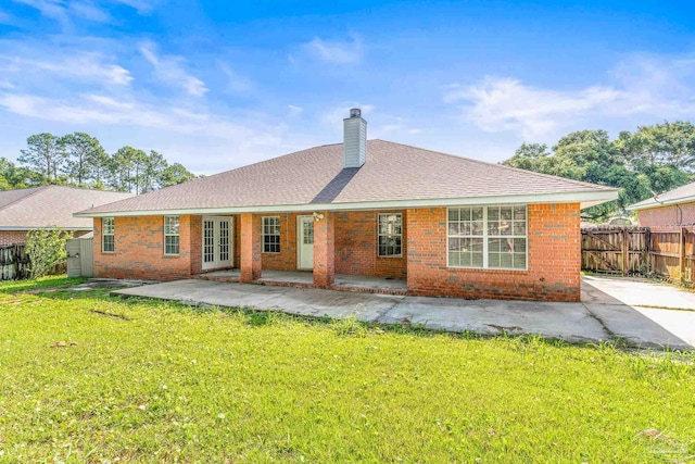 rear view of house with a patio area and a yard