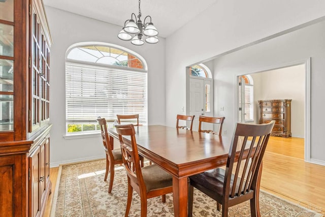 dining space featuring a chandelier and light wood-type flooring