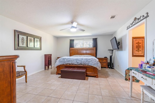 tiled bedroom featuring ceiling fan and a textured ceiling